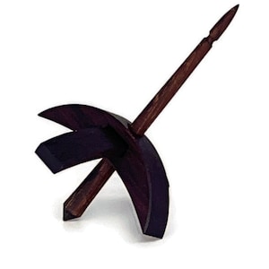 May include: A wooden spinning wheel with a dark brown finish. The wheel is made of two pieces, a crescent-shaped base and a spindle that extends out from the base.