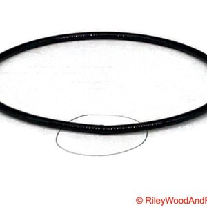 a piece of black drive band material. it is joined and has a circle indicating where the join is.