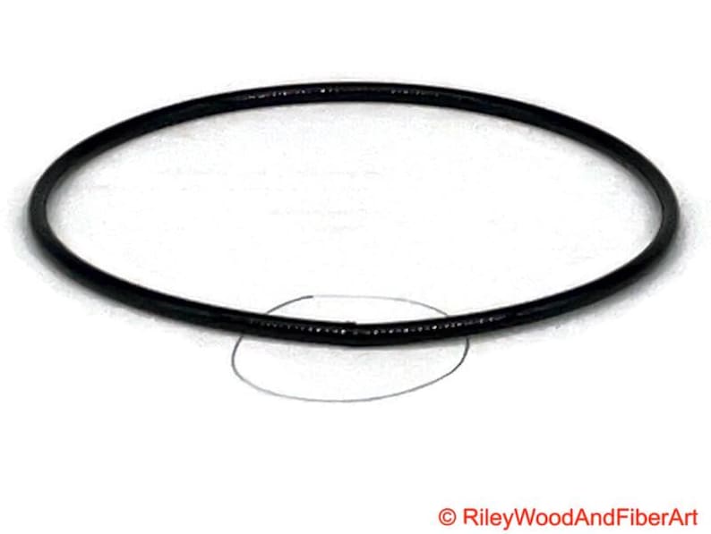 a piece of black drive band material. it is joined and has a circle indicating where the join is.