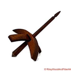 May include: A wooden spinning wheel with a brown spindle and a curved wooden base.