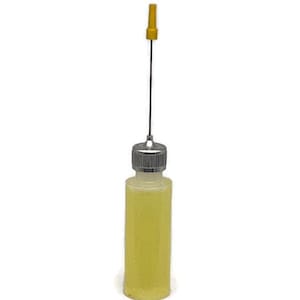 May include: A small, clear bottle filled with a yellow liquid, featuring a silver cap and a long, thin applicator with a yellow tip. The bottle is standing upright against a white background.