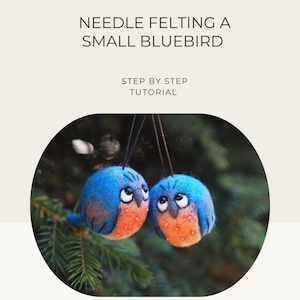 May include: Two needle-felted bluebird ornaments with orange chests and white eyes hang from black strings against a blurred green background. The text "NEEDLE FELTING A SMALL BLUEBIRD" and "STEP BY STEP TUTORIAL" are at the top.
