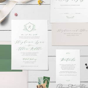 May include: A wedding invitation suite with a green and white color scheme. The invitation features a monogram with the letter "R" surrounded by greenery. The RSVP card has a green and white floral design. The details card has a green and white floral design and the text "Details". The text "Paper Tie Affair" is at the bottom of the image.