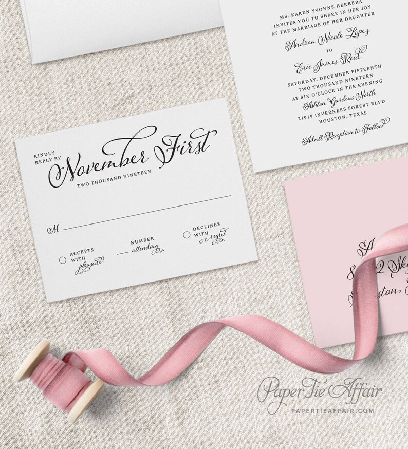 May include: A white RSVP card with black text. The card has a section for the guest to accept or decline the invitation, and a space to indicate the number of people attending. The text on the card reads "November First, Two Thousand Nineteen".