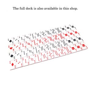May include: A full deck of playing cards arranged on a white surface. The cards are red, black, and white, with suits of hearts, diamonds, clubs, and spades. The text "The full deck is also available in this shop" is at the top.