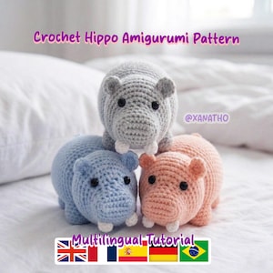 May include: A set of three ceramic canisters with lids. The canisters are white with a blue floral pattern. The largest canister is 8 inches tall, the medium is 7 inches, and the smallest is 6 inches.