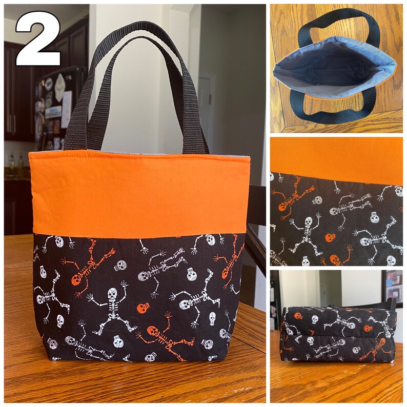 May include: A black and orange Halloween trick-or-treat bag with a skeleton and skull pattern. The bag has two black handles and a solid orange top section.