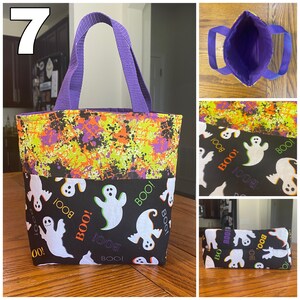 May include: Purple and black Halloween trick or treat bag with a ghost and "BOO!" print. The bag has a purple handle and a black and yellow splatter pattern on the top half.
