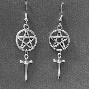 May include: Silver earrings with a pentagram charm and a sword charm hanging from each.