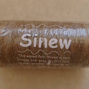 May include: A spool of brown waxed poly thread labeled "Arifidia Sinew". The label also states that the thread is very strong and easy to split into thinner strands for sewing or beading.