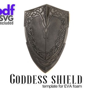 May include: A black shield with a Celtic knot design. The shield is made of EVA foam and is a template for crafting. The text "GODDESS SHIELD" and "template for EVA foam" is below the shield.