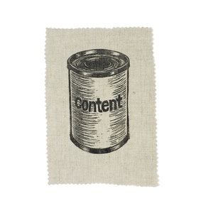 May include: A black and white illustration of a can with the word "Content" printed on it. The can is on a beige fabric with a scalloped edge. The can has a detailed, vintage style.