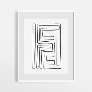 May include: Black and white abstract line art print in a white frame. The print features a geometric design with overlapping lines creating a maze-like pattern.
