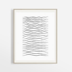 May include: A black and white abstract art print with a series of wavy lines in a vertical pattern. The print is framed in a light wood frame.