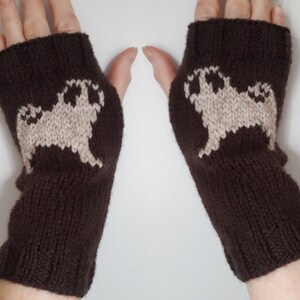 May include: Brown knit fingerless gloves with a white pug design on each glove.