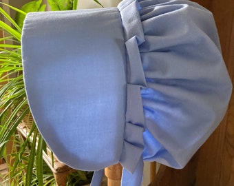 Girl's  bonnet Victorian style.  Light blue with decorative frill. Costume, book-day. School day . Stage.