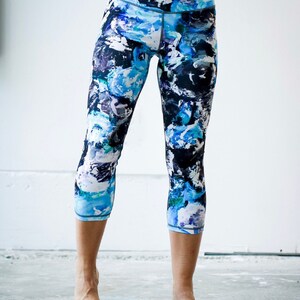 May include: Blue, black, and white patterned cropped leggings. The leggings have a high waist and a comfortable fit.