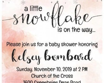 May include: A pink and white baby shower invitation with a snowflake design. The text reads "a little snowflake is on the way..." and includes the date, time, and location of the event. The invitation also states "Registered on Babylist.com".