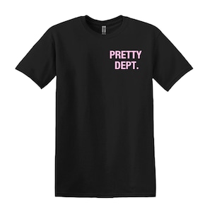 May include: Black t-shirt with the text "PRETTY DEPT." printed in pink on the upper left chest area. The shirt has short sleeves and a crew neck.