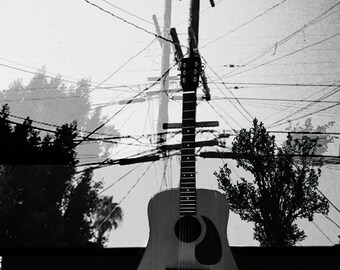 Strings.   Whimsy photo montage, guitar and cityscape