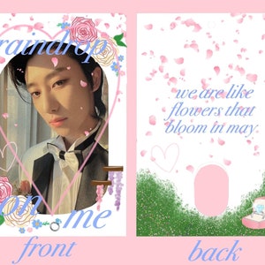 May include: A pink and blue card with a photo of a person on the front. The front of the card has the text "raindrop on me" and a heart shape. The back of the card has the text "we are like flowers that bloom in may." and a ring in a box.