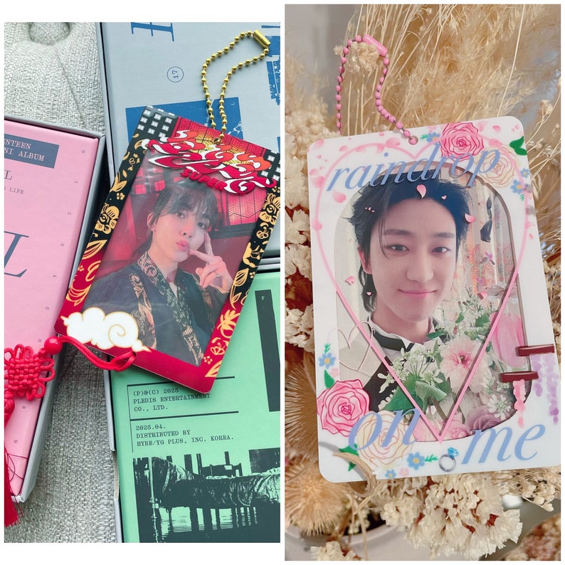 May include: Two colorful photo card holders with chains. The first holder is red with gold accents and features a photo of a young man with dark hair. The second holder is white with pink and blue accents and features a photo of a young man with dark hair. The text "raindrop on me" is printed on the second holder.