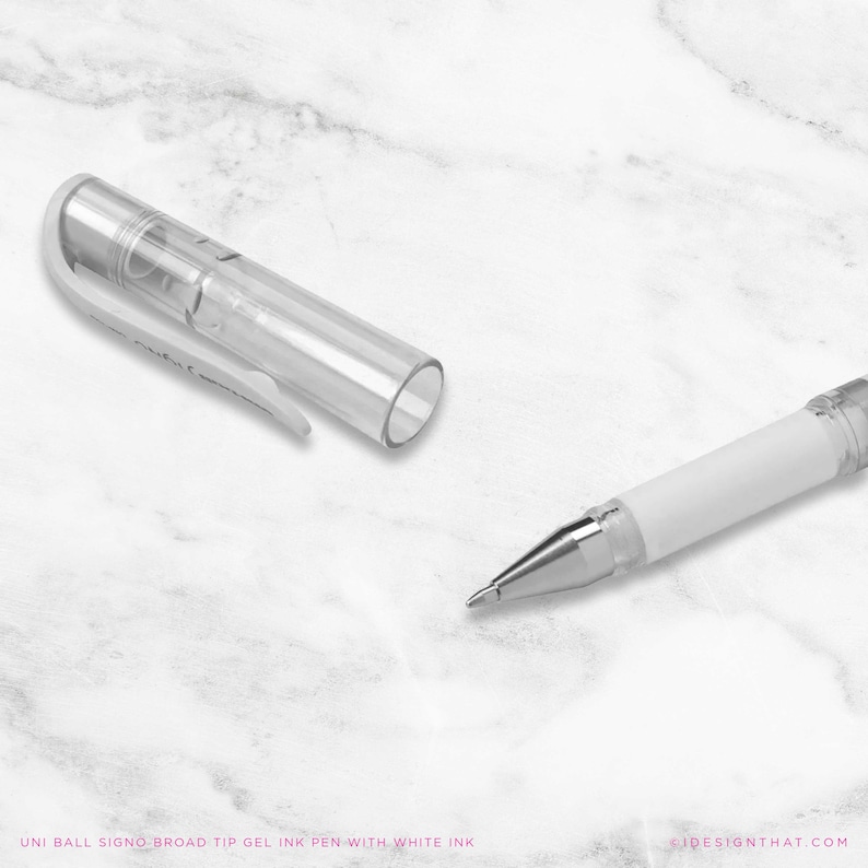 May include: A white and clear gel ink pen with the cap removed, showing the pen tip. The pen has a white barrel and a clear plastic cap. The text "UNI BALL SIGNO BROAD TIP GEL INK PEN WITH WHITE INK" is at the bottom of the image.