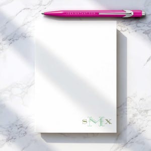 Monogram notepad with custom ink colors, designed as a polished writing pad for home or office notes.