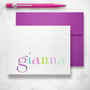 A violet envelope frames a rainbow stationery note card, adding bright flair to any colorful stationery kids note card set.
