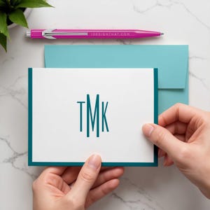 Timeless personalized notecards featuring a narrow vertical monogram that keeps the design polished and uncluttered.