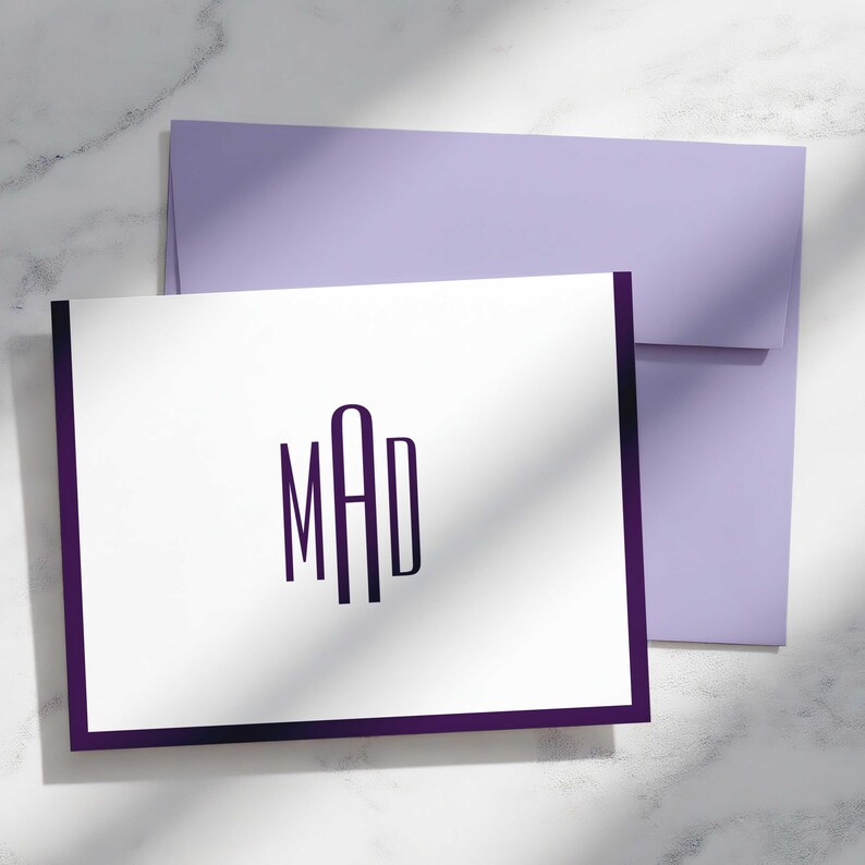 Personalized correspondence set with folded monogram notecards, custom colors, and envelopes ready for mailing.