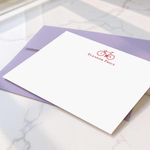 Flat notecard sets with personalized bicycle artwork, matching envelopes, and custom name for polished handwritten correspondence.