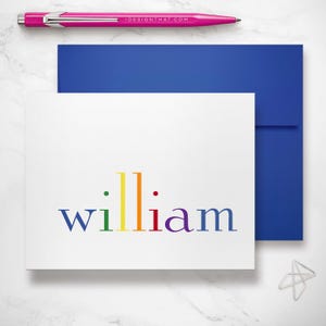 A blue‑enveloped rainbow stationery folded note card demonstrates a classic kids stationery set for personalized notes and thank you cards.