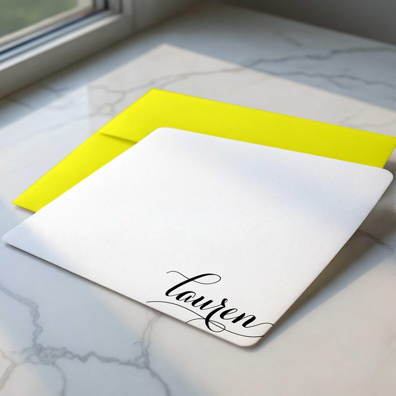 Custom note card with name in a decorative swash script, paired with colorful envelopes
