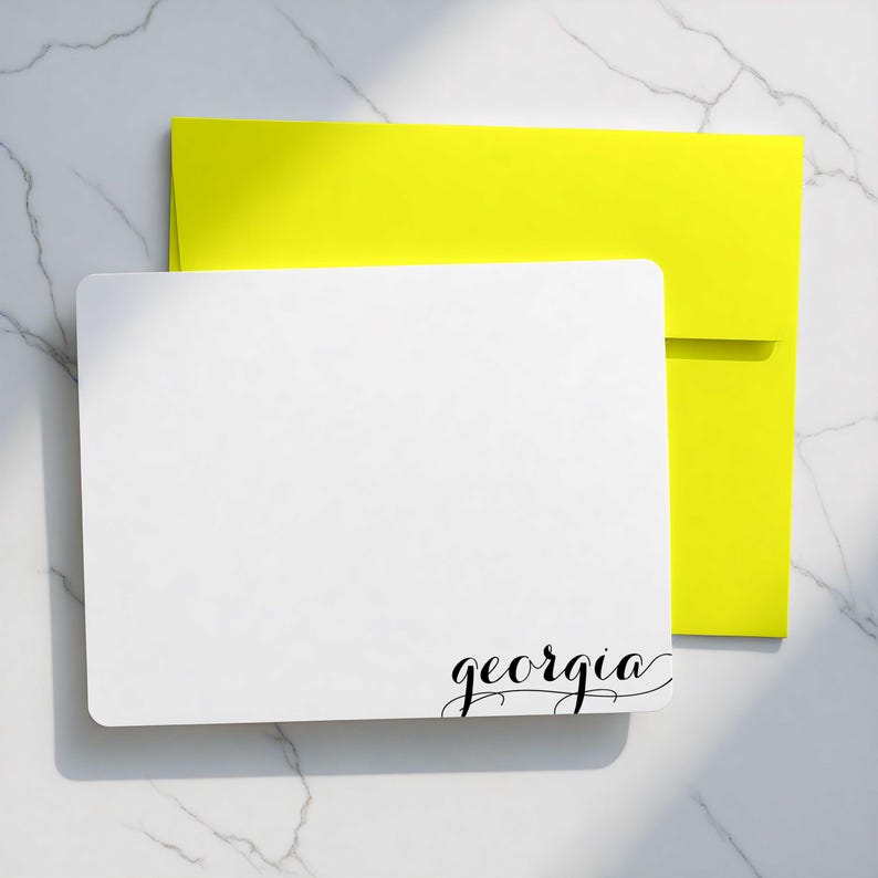 Personalized card with modern calligraphy name design, shown with bright envelope color options