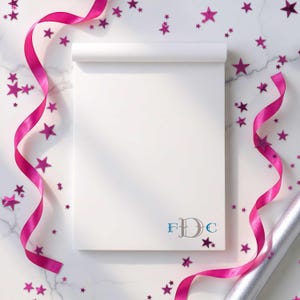 Monogrammed pad with smooth paper and personalized initials, useful for daily lists and quick reminders.