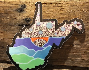 May include: A colorful sticker in the shape of West Virginia, featuring a landscape design. The sticker has a black border and depicts mountains, a sunset, and swirling patterns in shades of blue, green, purple, and orange.