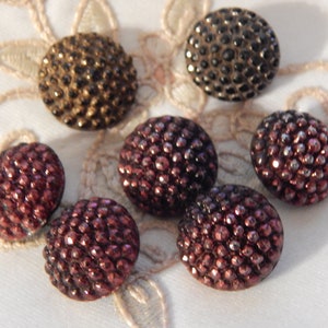 May include: Six vintage glass buttons with a textured, raised dot pattern. The buttons are in shades of brown, burgundy, and black.