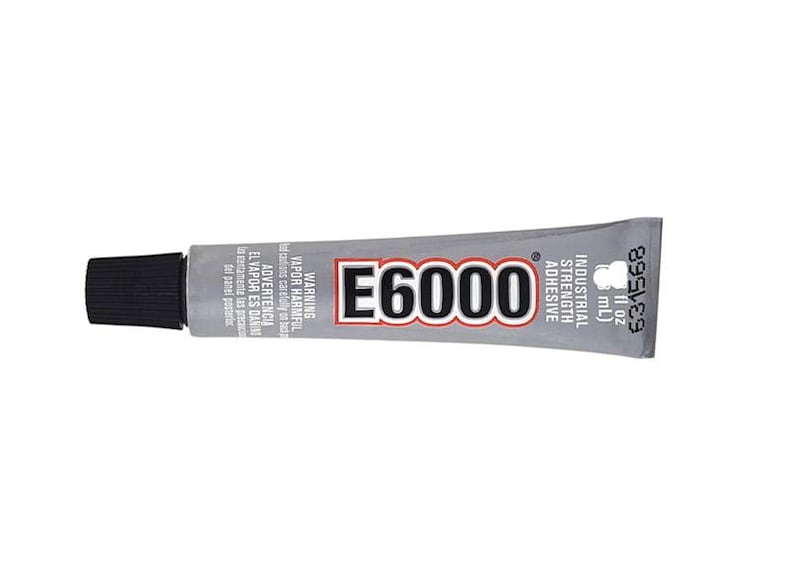 May include: A silver tube of E6000 industrial strength adhesive with a black cap. The tube is labeled with the product name, warnings, and measurements in both ounces and milliliters.