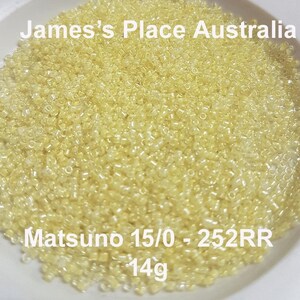 May include: A close-up image of a bowl filled with small, translucent yellow beads. The beads are labeled "Matsuno 15/0 - 252RR - 14g".