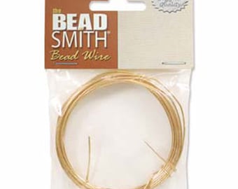 May include: A spool of gold-colored bead wire, packaged in a clear plastic bag with a brown header card that reads "The Bead Smith Bead Wire".