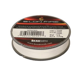 May include: A spool of white S-Lon Fire braided and fused bead thread. The label indicates a diameter of 0.15 mm, a length of 45.7 m, and a 2.72 kg test strength. The brand name The Beadsmith is printed on the top label with a barcode.
