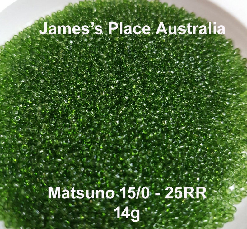 May include: A close-up image of a large quantity of small, green glass seed beads. The beads are in a white bowl. The text "James's Place Australia" and "Matsuno 15/0 - 25RR 14g" is visible in the image.