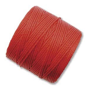 May include: A spool of bright red thread.