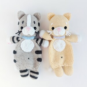 May include: Two crocheted cat toys, one gray and one yellow. Both have white accents and black eyes. They are made with a soft yarn and have a sweet, cuddly look.