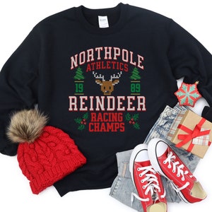 Pull laid de jeux de rennes pour les amateurs de sport, haut de champion d'athlétisme Northpole, sweat-shirt de Noël drôle pour la fête de bureau de vacances