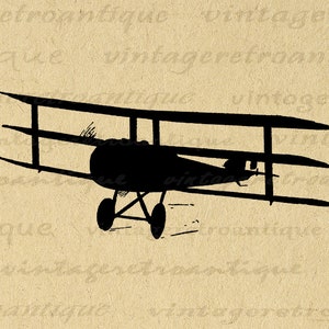 May include: Black silhouette of a vintage biplane aircraft with three wings. The plane is facing forward and has a propeller.