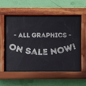 May include: A black chalkboard with a wooden frame, announcing "ALL GRAPHICS ON SALE NOW!" in white chalk.