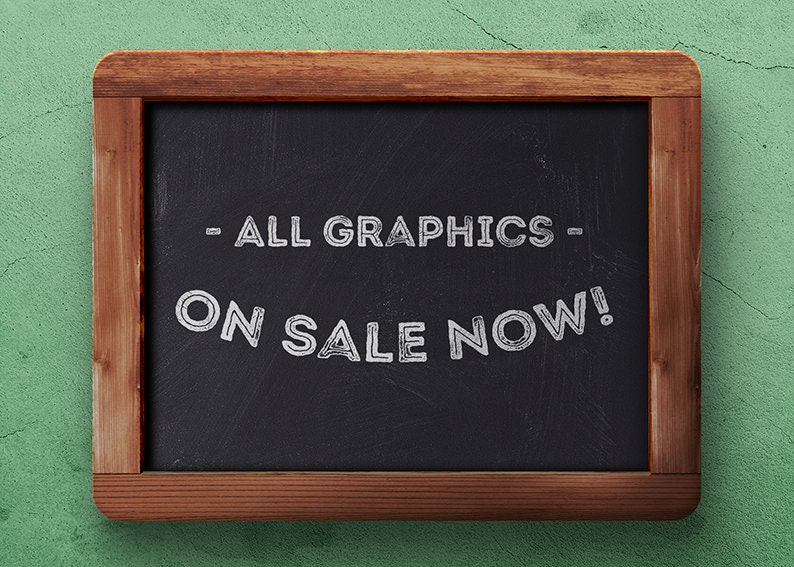 May include: A black chalkboard with a wooden frame, announcing "ALL GRAPHICS ON SALE NOW!" in white chalk.