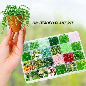 May include: A DIY beaded plant kit featuring a small terracotta-colored pot with a beaded green plant and a clear plastic organizer box filled with various green, pink, red, and yellow beads, including small mushroom and bee-shaped charms.